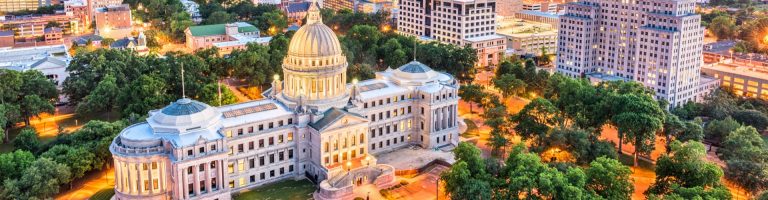 Mississippi State Capitol in Jackson at dusk, highlighting car shipping services across Mississippi