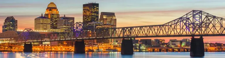 Scenic view of Louisville, KY with a bridge and skyline at sunset
