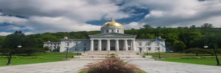 Vermont State House with a golden dome, surrounded by greenery
